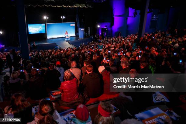 Gerneral overview shows German Chancellor and Chairwoman of the German Christian Democrats Angela Merkel as she speaks to supporters during the...