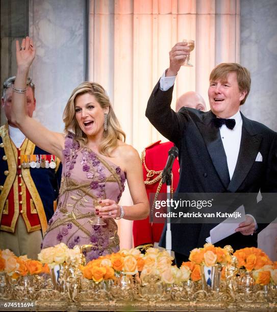 King Willem-Alexander of the Netherlands and Queen Maxima of The Netherlands raise a toast at a dinner for 150 Dutch people to celebrate the king's...