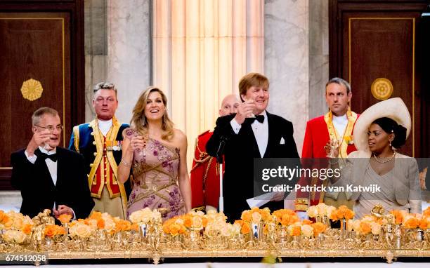 King Willem-Alexander of the Netherlands and Queen Maxima of The Netherlands raise a toast at a dinner for 150 Dutch people to celebrate the king's...