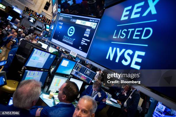 Traders work on the floor of the New York Stock Exchange as monitors display Emerald Expositions Events Inc. Signage during the company's initial...