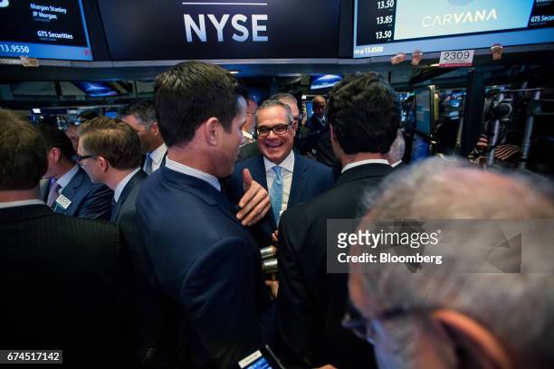 Ernest Garcia II, chairman of Carvana Co., center, laughs during the company's initial public offering on the floor of the New York Stock Exchange...