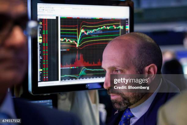 Trader works on the floor of the New York Stock Exchange in New York, U.S., on Friday, April 28, 2017. U.S. Stocks remained near record highs,...