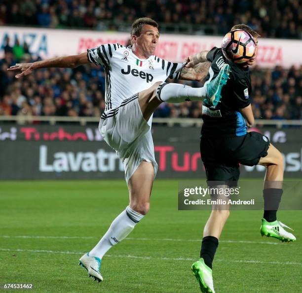 Mario Mandzukic of Juventus FC competes for the ball with Andrea Conti of Atalanta BC during the Serie A match between Atalanta BC and Juventus FC at...