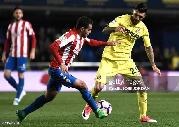 Sporting Gijon's Brazilian defender Douglas vies with Villarreal's Italian midfielder Roberto Soriano during the Spanish league football match...