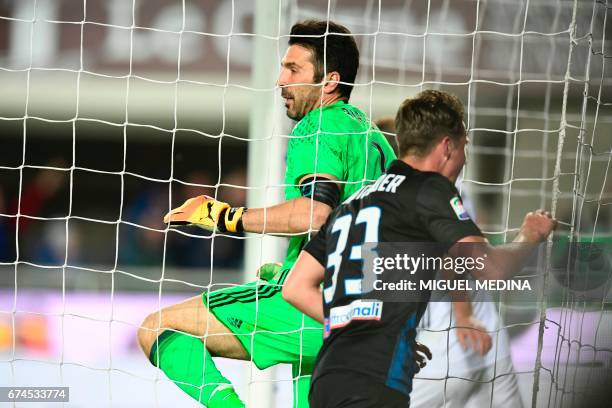 Atalanta's Dutch defender Hans Hateboer celebrates after Atalanta's Italian defender Andrea Conti scores against Juventus goalkeeper Gianluigi Buffon...