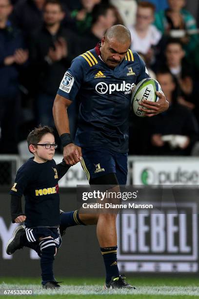 Patrick Osborne of the Highlanders leads the team out on to the field for his 50th match during the round 10 Super Rugby match between the...