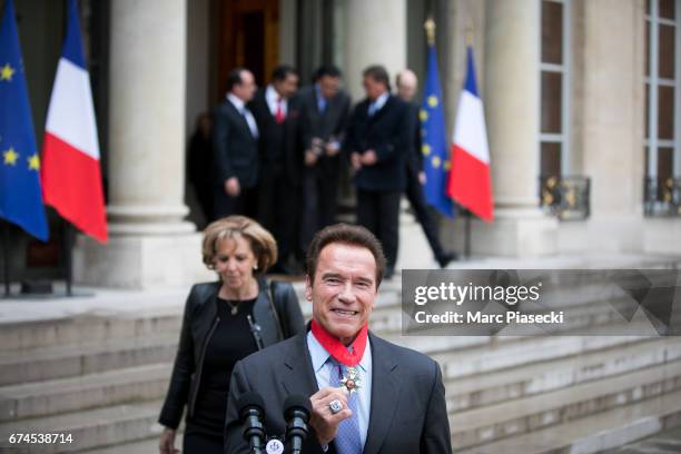 Arnold Schwarzenegger speaks to the press after being awarded France's highest national order the 'Chevalier de la Legion d'Honneur' by french...