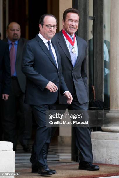 French President Francois Hollande is seen with Arnold Schwarzenegger after being awarded France's highest order the 'Chevalier de la Legion...