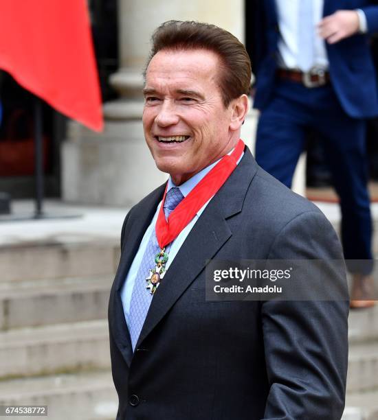 Former US Governor of California and actor Arnold Schwarzenegger shows his 'Chevalier de la Legion d'Honneur' medal, which he received from French...