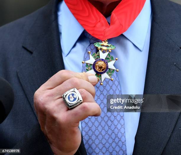 Former US Governor of California and actor Arnold Schwarzenegger shows his 'Chevalier de la Legion d'Honneur' medal, which he received from French...