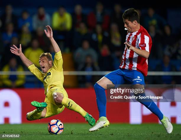 Roberto Soldado of Villarreal is tackled by Jorge Mere of Real Sporting de Gijon during the La Liga match between Villarreal CF and Real Sporting de...