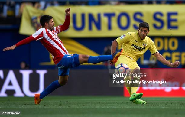 Jose Angel of Villarreal competes for the ball with Carlos Carmona of Real Sporting de Gijon during the La Liga match between Villarreal CF and Real...