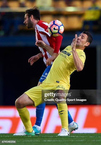 Daniele Bonera of Villarreal competes for the ball with Duje Cop of Real Sporting de Gijon during the La Liga match between Villarreal CF and Real...