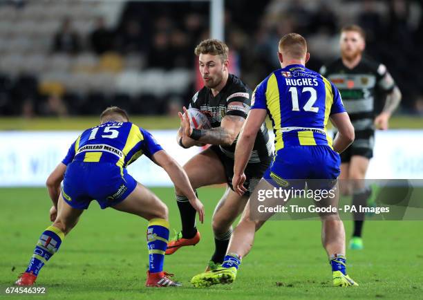Hull FC's Jansin Turgut is tackled by Warrington Wolves' Brad Dwyer and Jack Hughes during the Betfred Super League match at the KCOM Stadium, Hull.