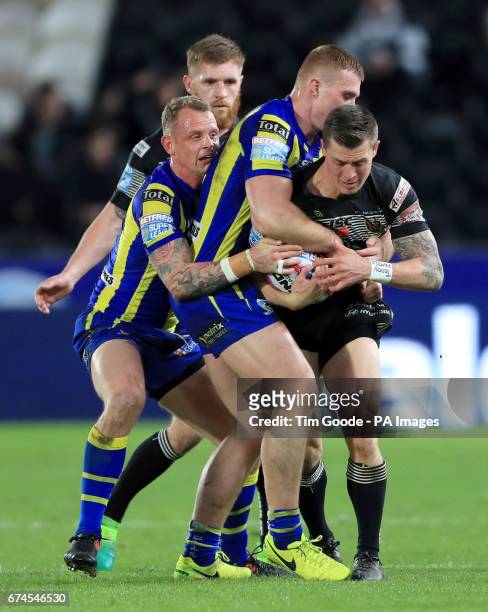 Hull FC's Jamie Shaul is tackled by Warrington Wolves' Jack Hughes and Kevin Brownduring the Betfred Super League match at the KCOM Stadium, Hull.