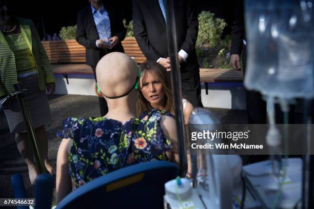 First lady Melania Trump greets a young patient at the Children's National Health System April 28, 2017 in Washington, DC. Trump spoke a the opening...