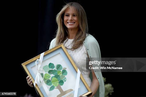 First lady Melania Trump hold a gift presented to her by 7-year-old Noah Haas before speaking at the Children's National Health System April 28, 2017...