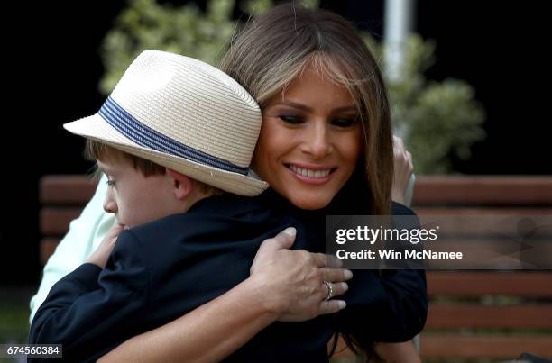 First lady Melania Trump hugs 7-year-old Noah Haas after he presented her with a gift at the Children's National Health System April 28, 2017 in...