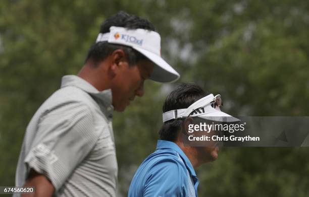 Choi of Korea and Charlie Wi walk from the tee during the second round of the Zurich Classic at TPC Louisiana on April 28, 2017 in Avondale,...