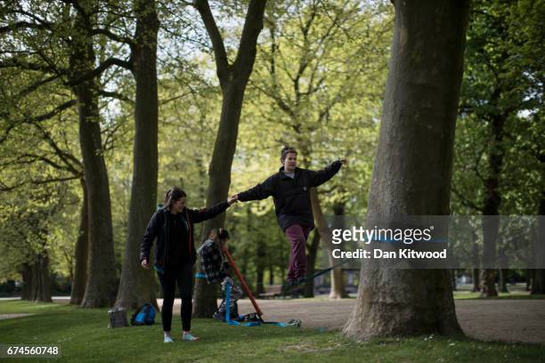 Group take turns balancing on a slackline in a park on April 28, 2017 in Brussels, Belgium. The 27 members of the European Union will meet in...