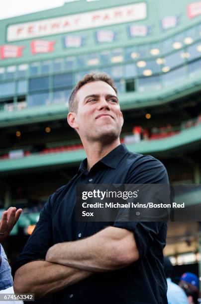 Chicago Cubs President of Baseball Operations Theo Epstein stands on the field during batting practice before a game against the Boston Red Sox at...