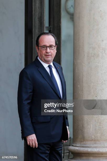 French president Francois Hollande looks on as he waits fot actor and former governor of California Arnold Schwarzenegger prior to a meeting at the...