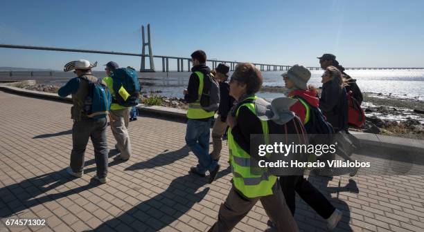 Pilgrims walk by Parque das Nacoes, starting point of the 'Camino do Tejo' , a 139 km trail, from Lisbon to Fatima Sanctuary on April 27, 2017 in...