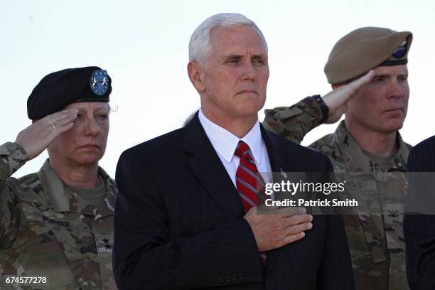 Vice President Mike Pence stands with his hand over his heart during a dignified transfer of U.S. Army Ranger Sgt. Cameron H. Thomas and U.S. Army...