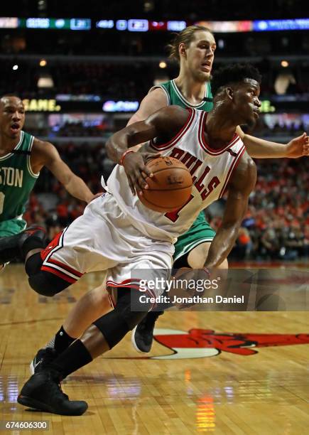 Jimmy Butler of the Chicago Bulls drives around Kelly Olynyk of the Boston Celtics during Game Six of the Eastern Conference Quarterfinals during the...