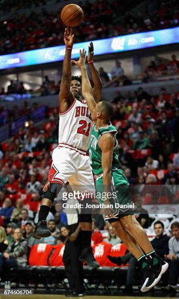 Jimmy Butler of the Chicago Bulls shoots over Avery Bradley of the Boston Celtics during Game Six of the Eastern Conference Quarterfinals during the...