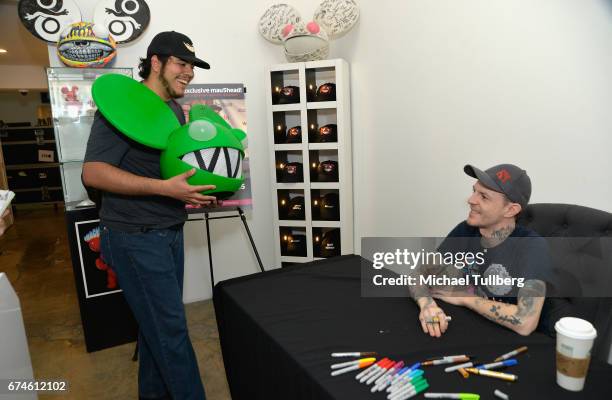 Electronic musician deadmau5 greets a fan carrying a deadmau5 head at deadmau5 and FANCY.com's pop-up shop "Lots Of Stuff In A Store" on April 28,...