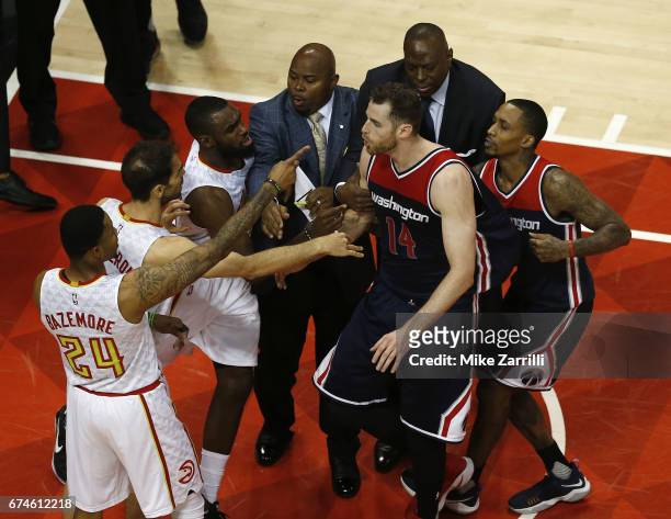 Guard Kent Bazemore of the Atlanta Hawks points at forward Jason Smith of the Washington Wizards during a scuffle on the court during Game Six of the...