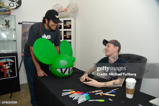 Electronic musician deadmau5 greets a fan carrying a deadmau5 head at deadmau5 and FANCY.com's pop-up shop "Lots Of Stuff In A Store" on April 28,...