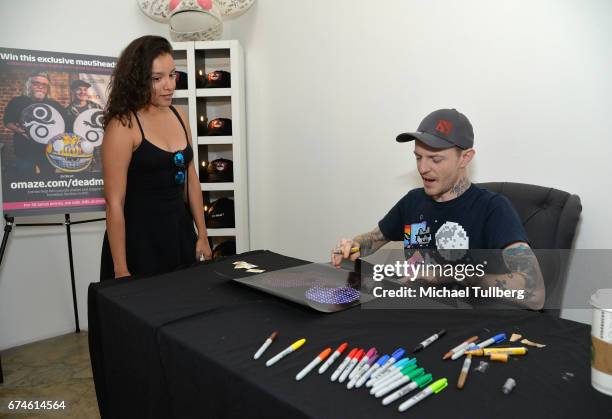 Electronic musician deadmau5 signs an autograph for a fan at deadmau5 and FANCY.com's pop-up shop "Lots Of Stuff In A Store" on April 28, 2017 in Los...