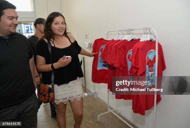 Fan examines some deadmau5 merchandise at electronic musician deadmau5 and FANCY.com's pop-up shop "Lots Of Stuff In A Store" on April 28, 2017 in...