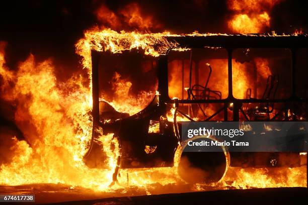 Bus burns after being set on fire by protestors during a nationwide general strike on April 28, 2017 in Rio de Janeiro, Brazil. The general strike...