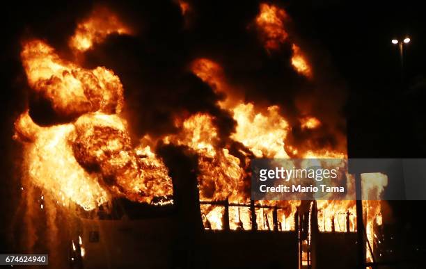 Bus burns after being set on fire by protestors during a nationwide general strike on April 28, 2017 in Rio de Janeiro, Brazil. The general strike...