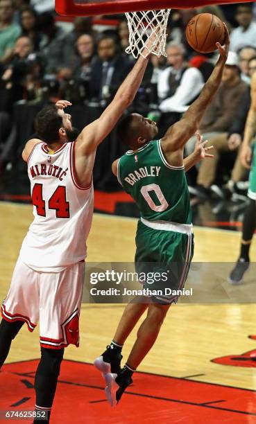 Avery Bradley of the Boston Celtics drives past Nikola Mirotic of the Chicago Bulls on his way to a team-high 23 points during Game Six of the...
