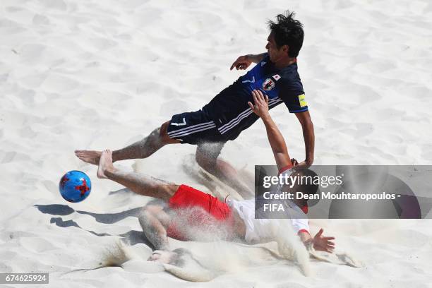 Konrad Kubiak of Poland tackles Teruki Tabata of Japan during the FIFA Beach Soccer World Cup Bahamas 2017 group D match between Japan and Poland at...