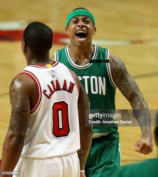 Isaiah Thomas of the Boston Celtics celebrates after an assist that lead to a dunk as Isaiah Canaan of the Chicago Bulls walks to the bench during...