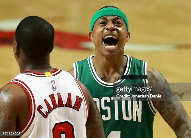 Isaiah Thomas of the Boston Celtics celebrates after an assist that lead to a dunk as Isaiah Canaan of the Chicago Bulls walks to the bench during...