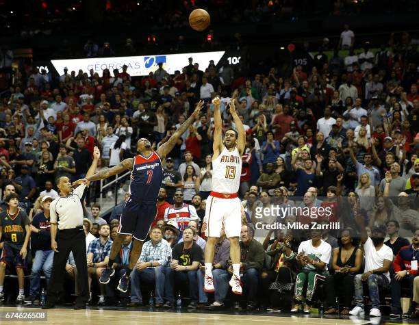 Forward Jose Calderon of the Atlanta Hawks shoots over guard Brandon Jennings of the Washington Wizards during Game Six of the Eastern Conference...