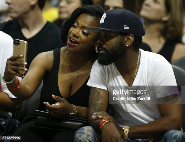 Real Housewives of Atlanta" cast member Kandi Burress takes a selfie with her husband, Todd Tucker, during Game Six of the Eastern Conference...