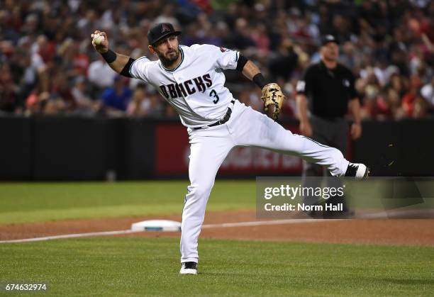 Daniel Descalso of the Arizona Diamondbacks makes a running throw to first base to get a force out during the fourth inning against the Colorado...