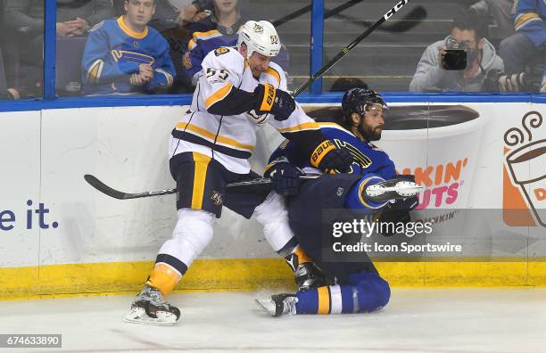 Nashville leftwing Cody McLeod and St. Louis Blues center Kyle Brodziak battle for the puck during game 1 of the second round of the 2017 Stanley Cup...