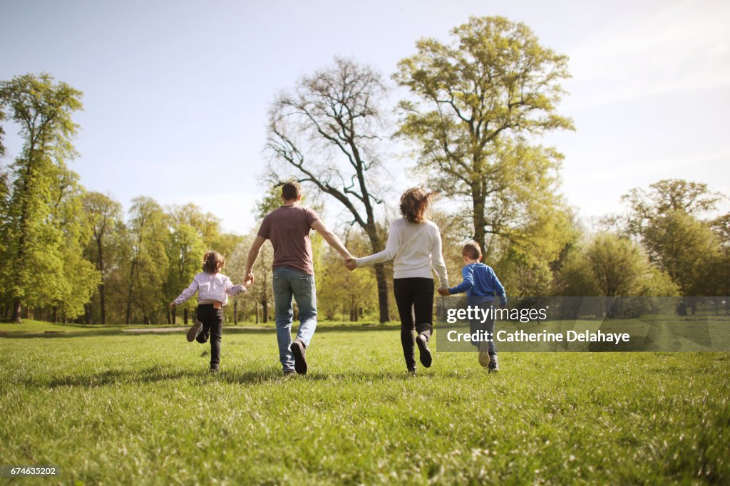 A family running together in a park