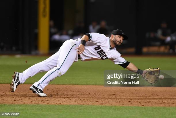 Daniel Descalso of the Arizona Diamondbacks makes a diving stop on a ground ball during the sixth inning against the Colorado Rockies at Chase Field...