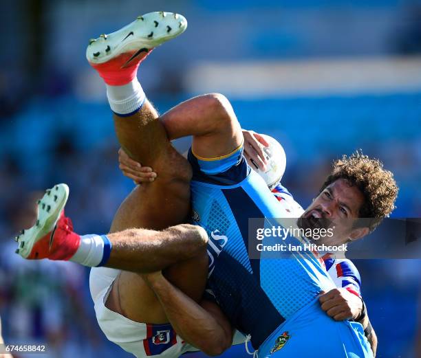 Dane Gagai of the Knights is tackled by Jarryd Hayne of the Titans during the round nine NRL match between the Gold Coast Titans and the Newcastle...