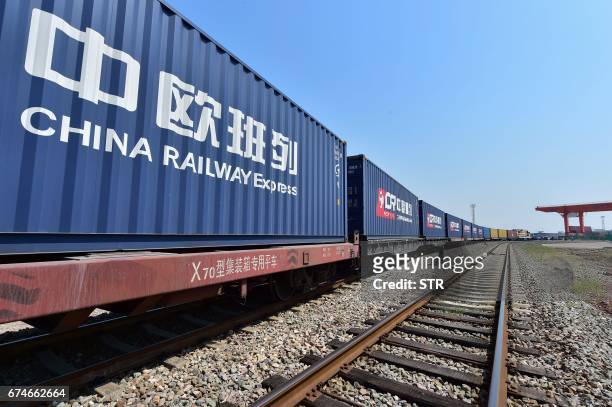 Freight train transporting containers laden with goods from London, arrives at Yiwu railway port station in Yiwu, east China's Zhejiang province on...