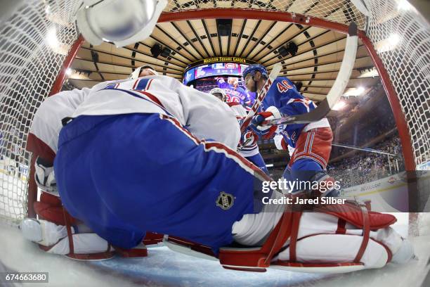 Michael Grabner of the New York Rangers battles at the net against Carey Price of the Montreal Canadiens in Game Six of the Eastern Conference First...